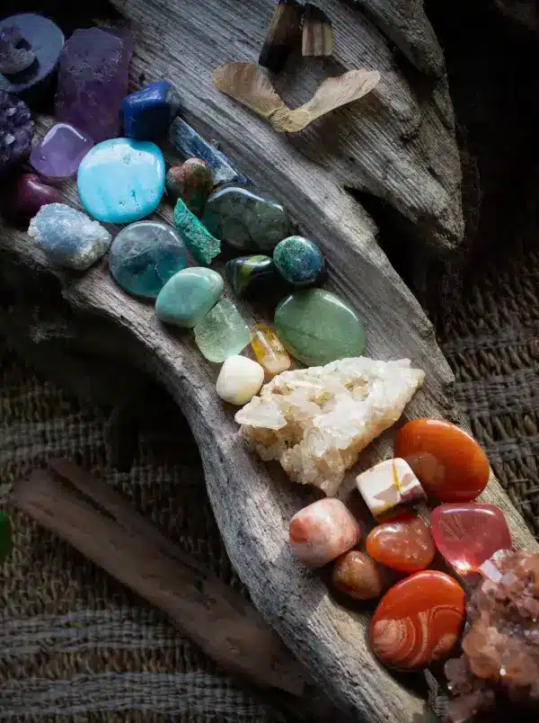 chakra river of gem stones on driftwood